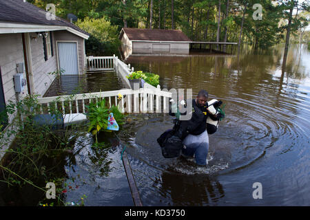 NFL player Clifton Geathers with the Pittsburgh Steelers retrieves any possessions not destroyed by the flood at his family home in Brown's Ferry near Georgetown, South Carolina, Oct. 10, 2015. The South Carolina National Guard has been activated to support state and county emergency management agencies and local first responders as historic flooding impacts counties statewide. Currently, more than 3,000 South Carolina National Guard members have been activated in response to the floods. (U.S. Air National Guard photo by Tech. Sgt. Jorge Intriago/Released) Stock Photo