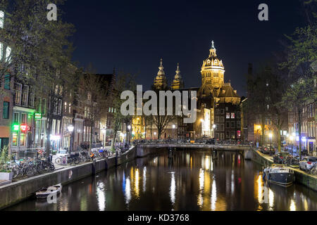 Amsterdam by night, with St Nicholas's Church in the distance, seen along the Voorburgwal Stock Photo