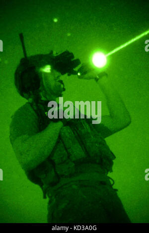 A U.S. Air Force Joint Terminal Attack Controller assigned to the 22nd Special Tactics Squadron uses a laser to designate a target for aircraft overhead at Poinsett Electronic Combat Range on Shaw Air Force Base, S.C., May 21, 2014.  Elements of the South Carolina Army and Air National Guard, U.S. Army and U.S. Air Force special operations, and Columbia Police Department S.W.A.T., conducted nighttime training, which allowed special operations forces and the National Guard to conduct joint urban assault training. (U.S. Army National Guard photo by Sgt. Brian Calhoun/Released)