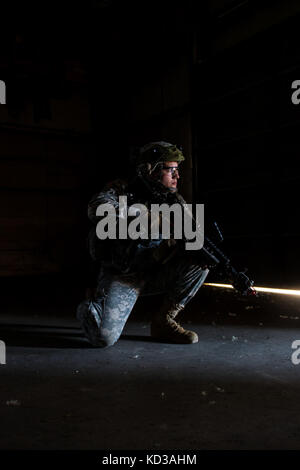 U.S. Army Soldiers, assigned to the 1-118th Combined Arms Battalion, South Carolina Army National Guard, assault a captured electrical facility at the Savannah River Site, Aiken, S.C., as part of Carolina Thunder 14, Nov. 15, 2014. South Carolina National Guard, along with North Carolina, Georgia, and Tennessee National Guard units conducted Carolina Thunder 14, joint training exercise, on a drill weekend. More than 30 aircraft participated in the mass take-off from McEntire Joint National Guard Base, Eastover, S.C. Units conducted air and ground operations at the Savannah River Site in Aiken, Stock Photo
