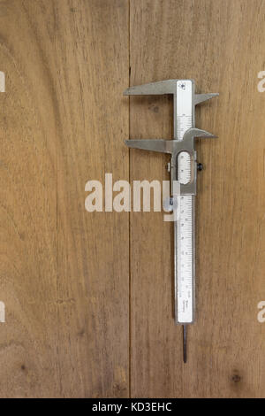 Vernier caliper on wooden background, flat lay Stock Photo