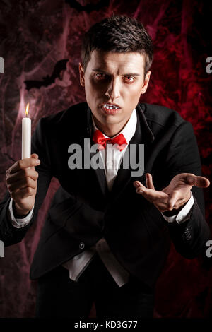 handsome man dressed in a Dracula costume for Halloween.  Stock Photo