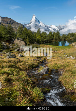 Snow-covered Matterhorn, stream flows into the Grindijsee, Valais, Switzerland Stock Photo