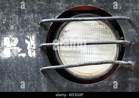 Round headlamp of an old excavator Stock Photo