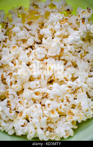 Scattered salted popcorn, texture background. Stock Photo