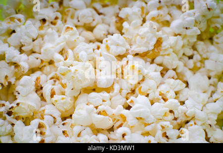 Scattered salted popcorn, texture background. Stock Photo