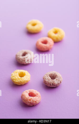 Colorful cereal rings on colorful background. Stock Photo