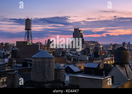 Chelsea rooftops at twilight with water towers. Manhattan, New York City Stock Photo