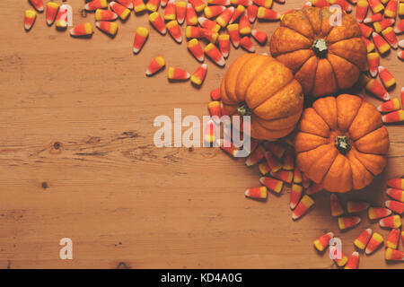 Pumpkin and candy corn autumn halloween background Stock Photo