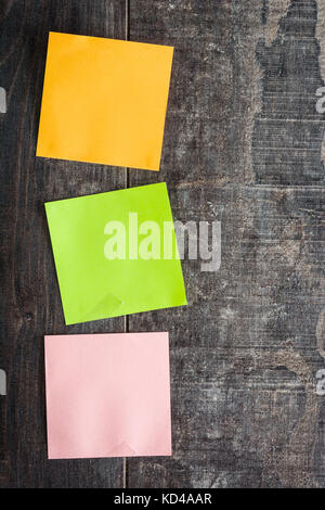 Colorful stick notes on wooden table. Copyspace. Stock Photo
