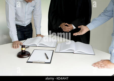 Judge gavel with Justice lawyers Plaintiff or defendant  meeting at law firm in background. Concept of law. Stock Photo