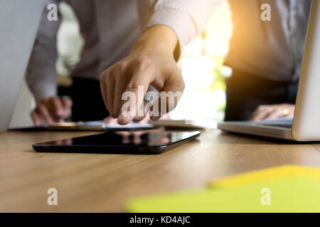 Two businessman working use computer and analysis paper graph on  table with computer and tablet Stock Photo