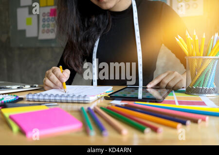 young fashion designer work on the table with tailor tool computer and tablet Stock Photo