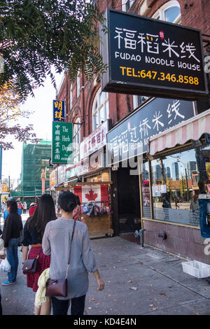 People walk down Spadina Ave in the Chinatown area of Toronto Ontario Canada Stock Photo