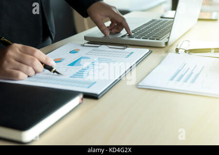 business man working with laptop on wood table for his success Stock Photo