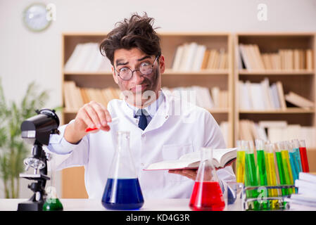 Mad crazy scientist doctor doing experiments in a laboratory Stock Photo