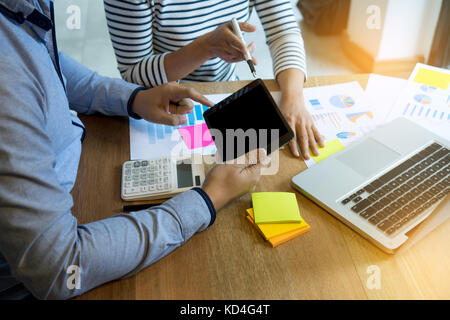 Business team  man and woman work with laptop on wood table with tablet screen clipping path Stock Photo