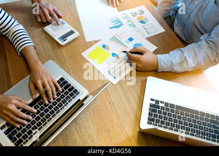 business team man and woman work with laptop on wood table Stock Photo