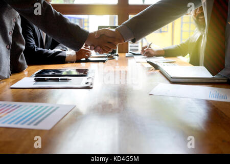 Group of businessman handshake  on wood table with computer Stock Photo