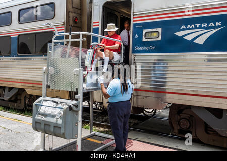 Orlando Florida,station,railroad,train,Amtrak,stop,Black man men male,woman female women,passenger passengers rider riders,disabled,wheelchair,lift,he Stock Photo