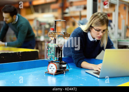 Young beautiful female engineer testing and programming Stock Photo
