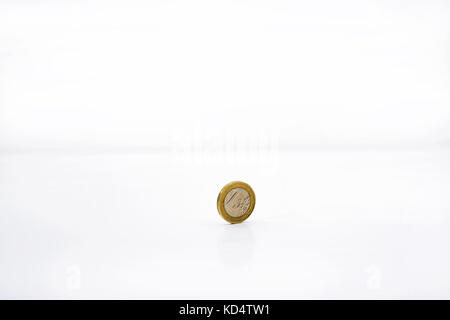 Small euro coin on white table. Abstract photo Stock Photo
