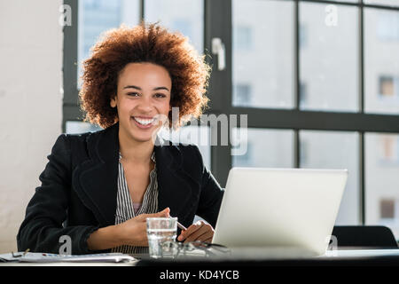 Woman working on laptop in the office Stock Photo