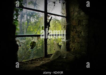 Old Milk Bottle Sitting On Window Sill In An Abandoned House Stock Photo