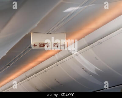 emergency exit sortie sign on the ceiling of airplane Stock Photo