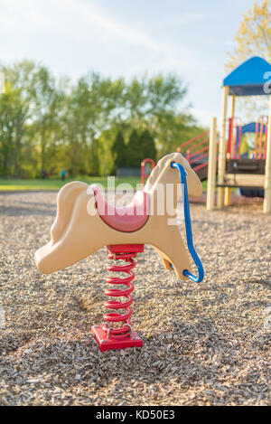 Rocking Horse in Playground Stock Photo