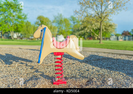 Rocking Horse in Playground Stock Photo