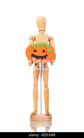 Wooden articulated doll holding a pumpkin cookie on the white isolated background Stock Photo