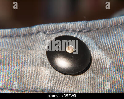 black circle button macro close up detail clothing; essex; england; uk Stock Photo