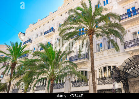 Mediterranean city street, view of the Hotel Reina Victoria in the palm tree lined Calle las Barcas in the center of Valencia, Spain. Stock Photo