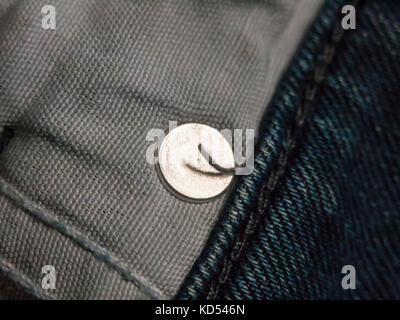close up of inside of pocket of jeans with metal circle; essex; england; uk Stock Photo