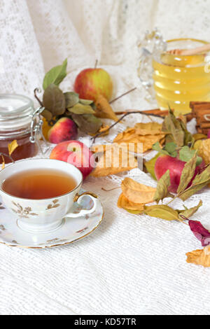 Vintage tea party - tea cups, apples and honey on white wooden table Stock Photo