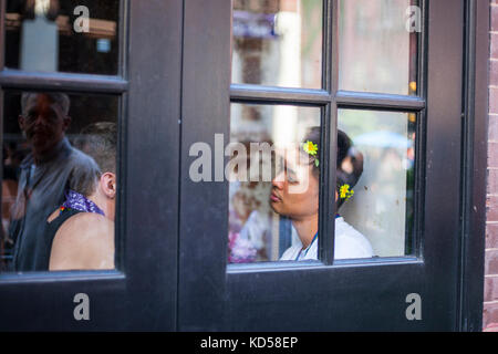 Mail gay couple in the bar on annual LGBT Pride Parade in the city, June 2017 Stock Photo
