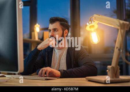 Attentive office worker doing his job Stock Photo