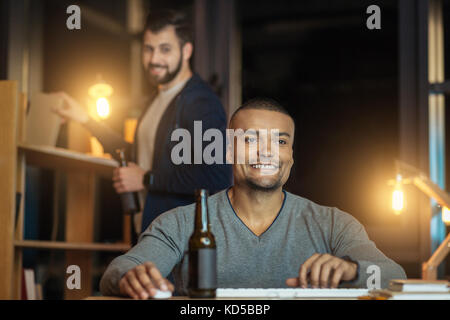 Happy man sitting at his workplace Stock Photo