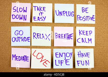 A yellow sticky note writing, caption, inscription Slow down, take ir easy be positive go outside relax breathe keep calm love what you do, do what you love, motivational concept on sticky notes Stock Photo