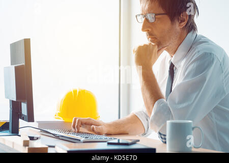Architect working in office, construction engineer working with computer and sketches making a construction project, selective focus Stock Photo