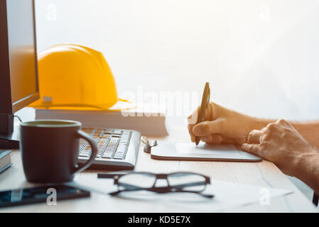 Architect construction engineer working with sketch pen tablet in office making a construction project in CAD software, selective focus Stock Photo
