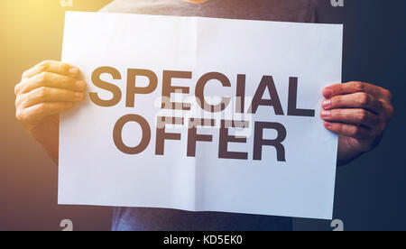 Man holding banner with Special offer text printed Stock Photo