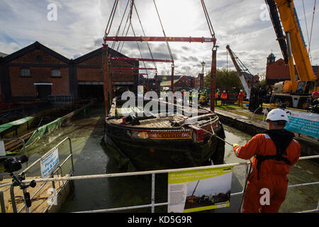 Work underway to raise 11 sunken canal boats to be restored and displayed at The Boat Museum in Ellesmere Port, Cheshire. Stock Photo