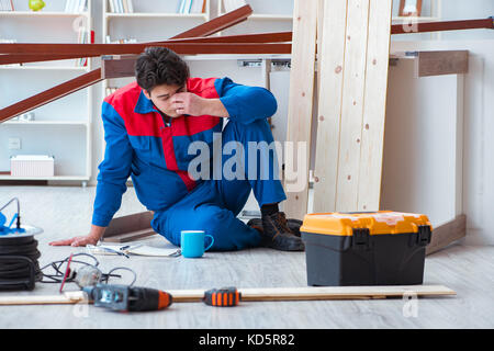 Young carpenter at work tired feeling not well Stock Photo
