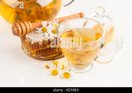 Honeycomb and chamomile tea on white Stock Photo