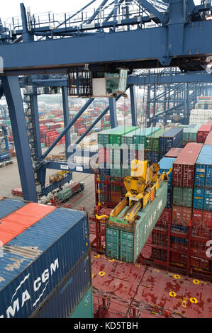 Shipping containers in container port and on-board ship Stock Photo
