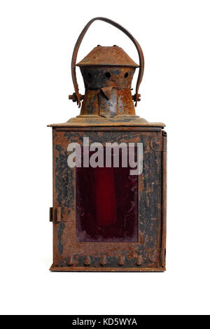 Isolated objects: very old shabby and rusty lantern, with red glass, on white background Stock Photo