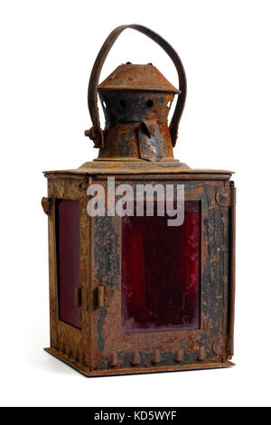 Isolated objects: very old shabby and rusty lantern, with red glass, on white background Stock Photo