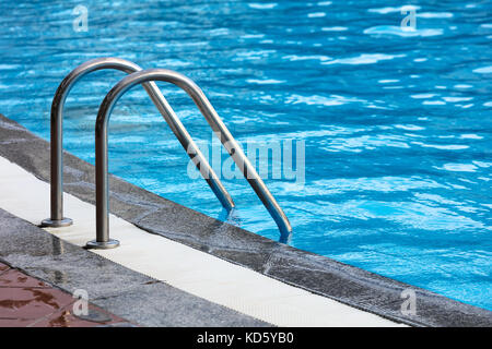 steel railings stairs pool with reflection Stock Photo